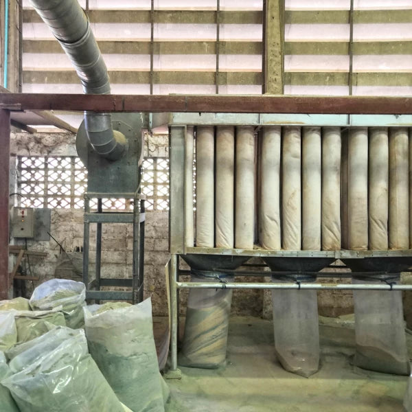 dust collection bags full of dust under a dust collector