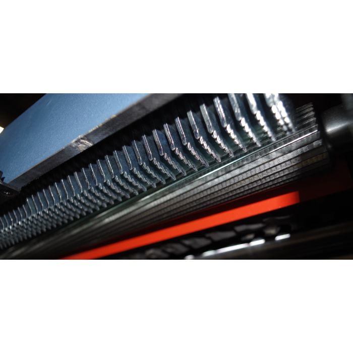 close-up view of serrated feed roll for slip-free feeding and anti-kickback device
